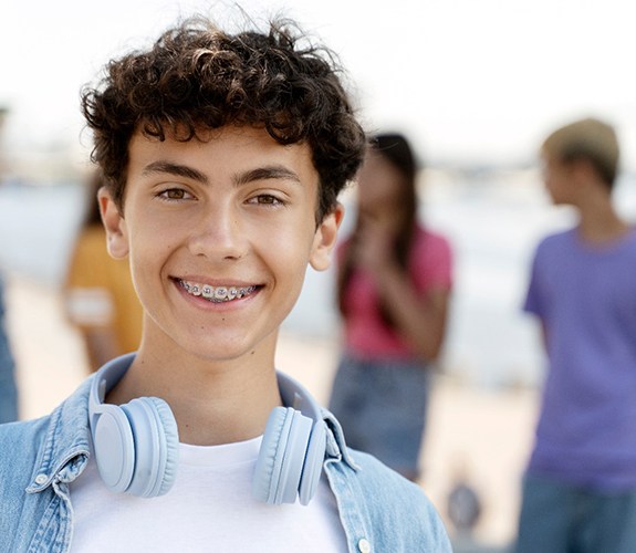Teenage boy on beach with braces in Marion, IN