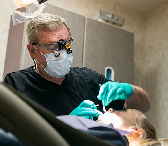 Young person receiving dental checkup during first appointment
