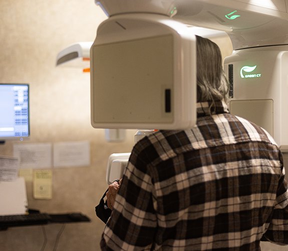 Woman receiving 3 D C T cone beam dental x-ray scan