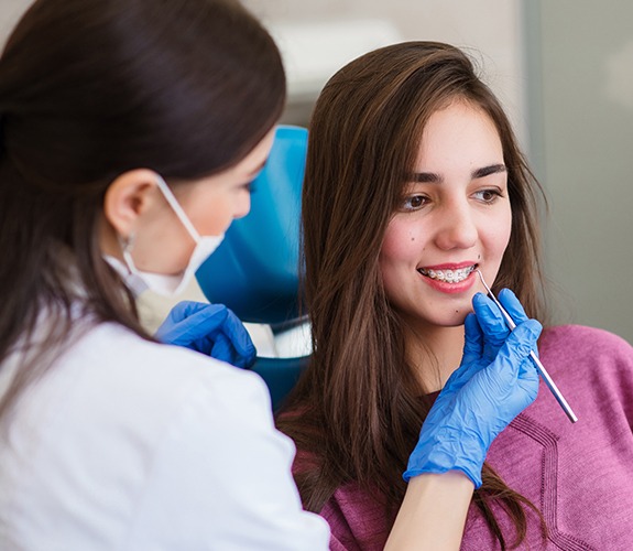 Woman receiving braces adjustment