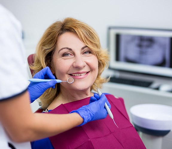 A mature woman who’s just received a dental bridge