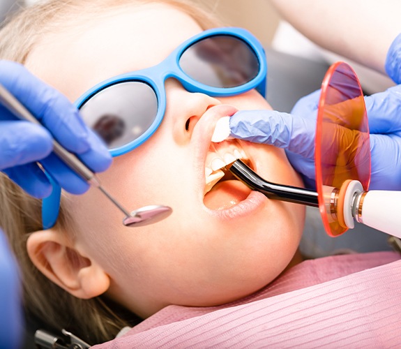 Child receiving dental sealant treatment