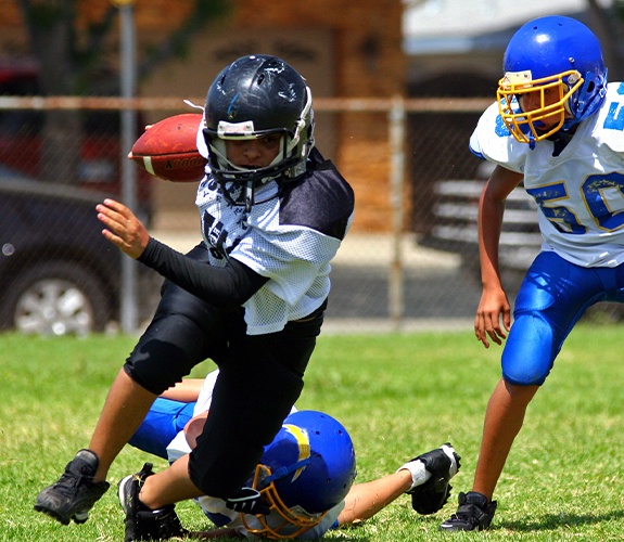 Kids with athletic mouthguards playing football
