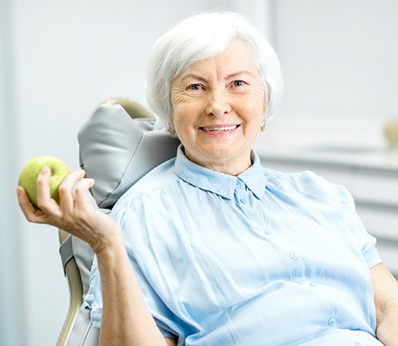 Woman smiling with dentures in Marion