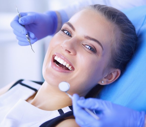 Patient in dental chair smiling