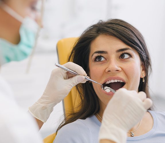 Woman receiving wisdom tooth extraction