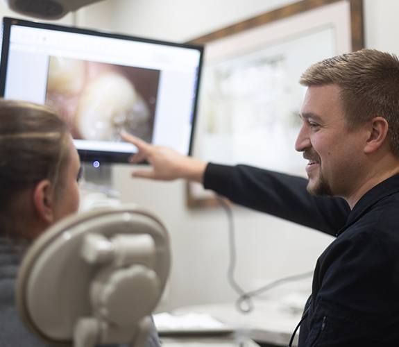 Mother and child talking to dentist during dental office visit