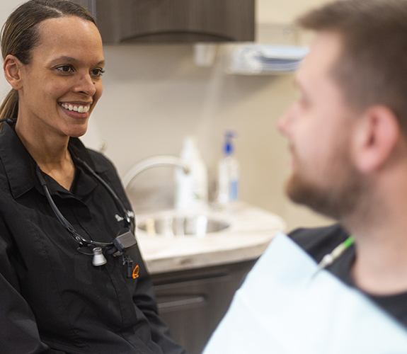 Dental team member and patient reviewing dental treatment costs