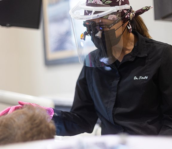 Woman smiling during dentistry treatment