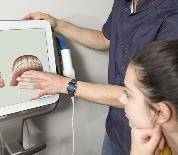 Woman reviewing Invisalign clear braces treatment plan with dentist