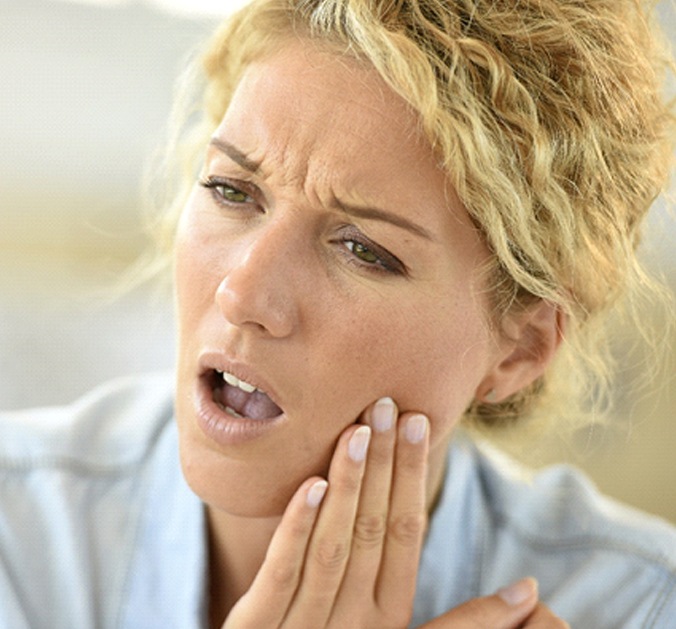 Woman with mouth pain due to a grinding teeth habit