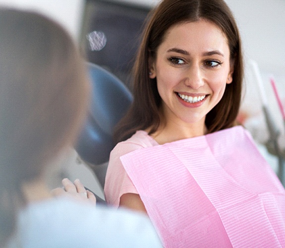 Woman smiling at her dentist in Marion