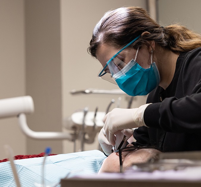 Older man and woman smiling after oral cancer screening