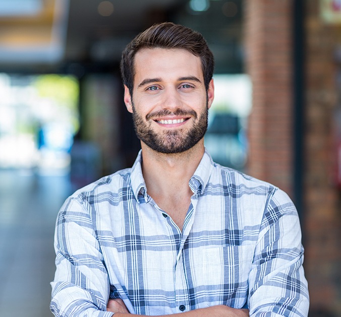 Man with healthy smile after oral surgery