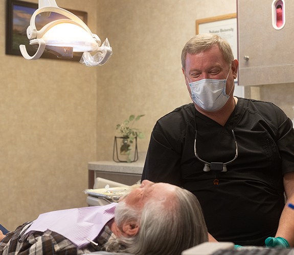 Woman talking to dentist about oral surgery