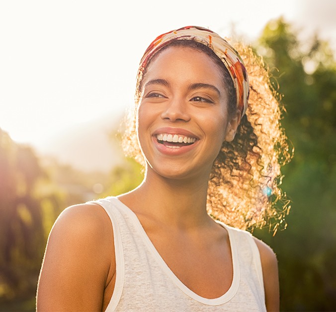 Woman with healthy smile after orthodontic treatment