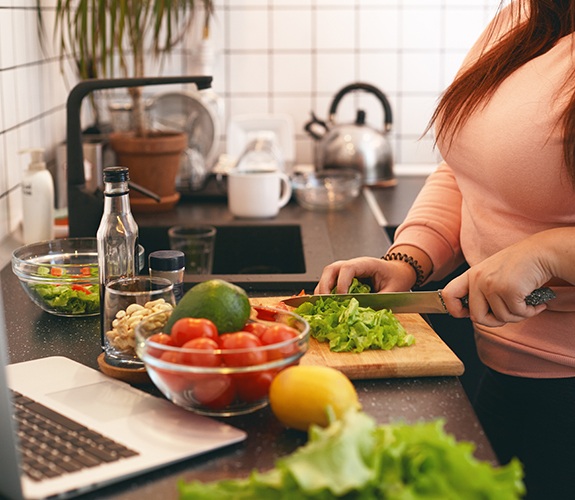 Woman chopping vegetables in kitchen