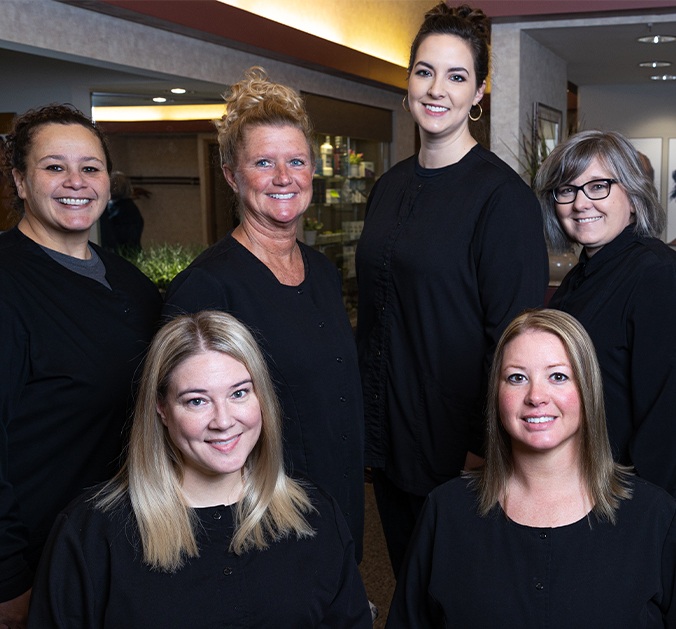 Mother father and daughter laughing together after preventive dentistry