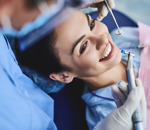 Woman receiving dental checkup and teeth cleaning