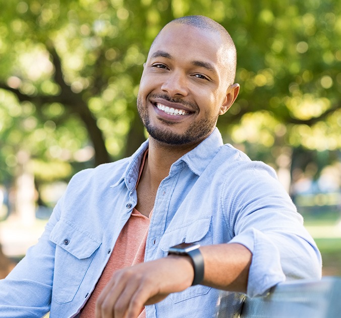 Young man smiling after root canal therapy