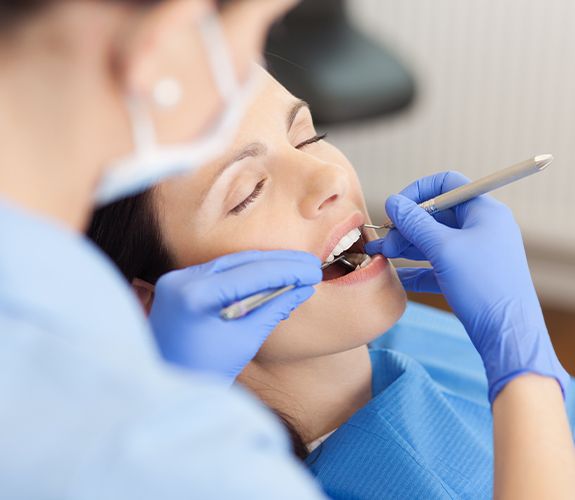 Patient under sedation dentistry receiving treatment