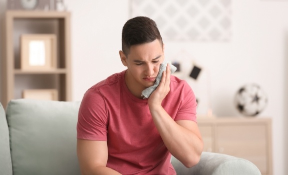 Man holding jaw in pain