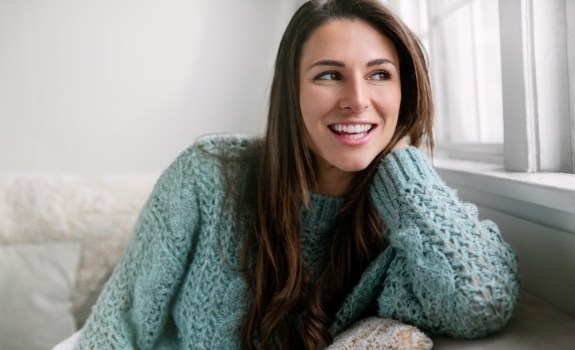 Woman with beautiful smile after orthodontic treatment