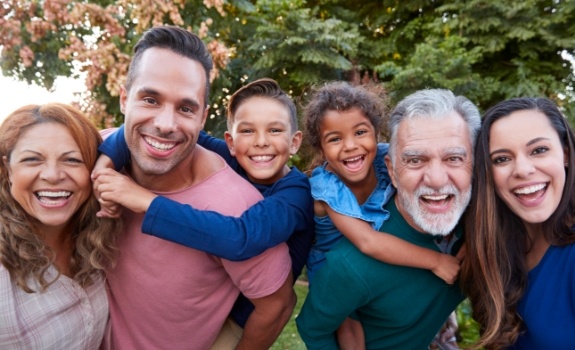 Three generations of family with healthy smiles after preventive dentistry