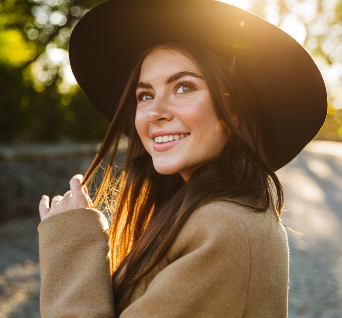 Woman with tooth colored fillings smiling outdoors