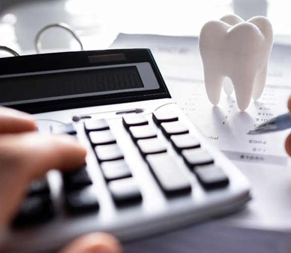 A patient calculating the cost of teeth whitening 