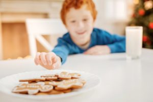 red head boy reaching for cookie