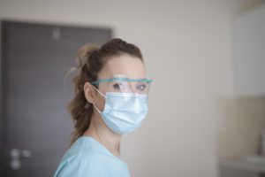 Dentist in Marion wearing mask and face shield.