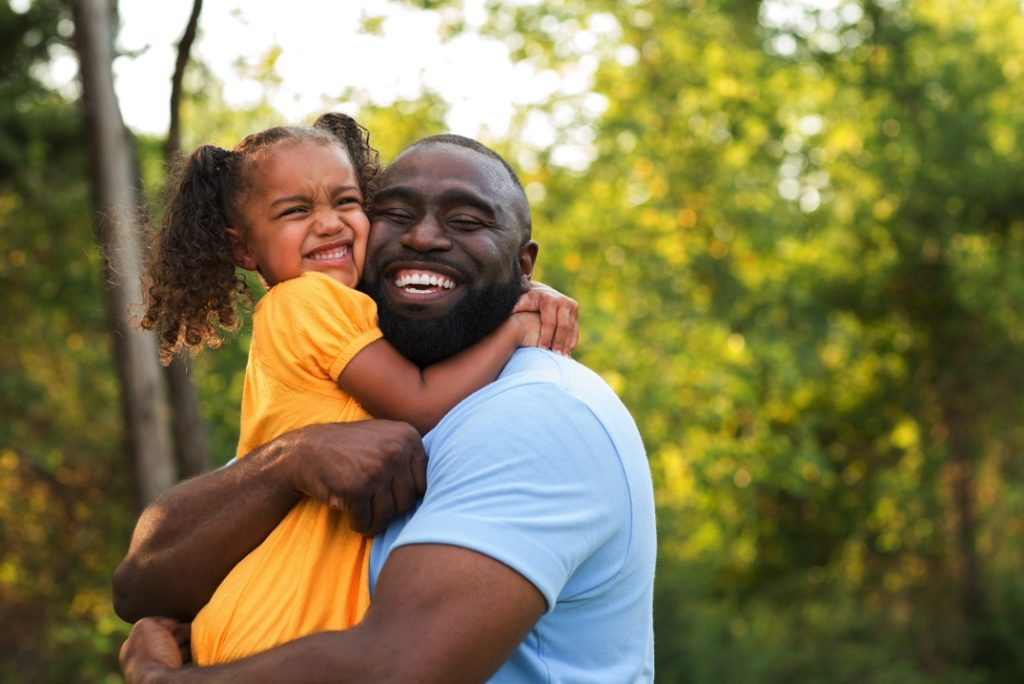 Father and daughter smiling