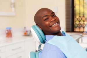 Man smiles after treatment from his Marion oral surgeon