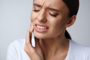 Woman in pain from grinding teeth