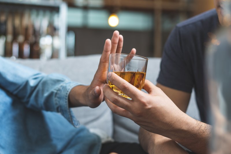 Person refusing alcohol after tooth extraction